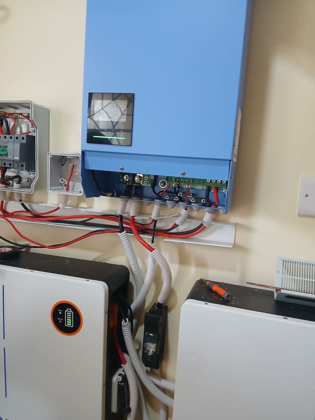 Close-up of inverter cable terminations above battery units